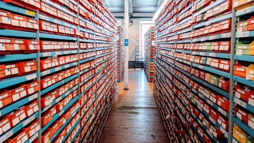 Long aisles of organized shoe boxes in a warehouse
