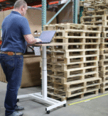 Worker using a warehouse stock management system in a warehouse