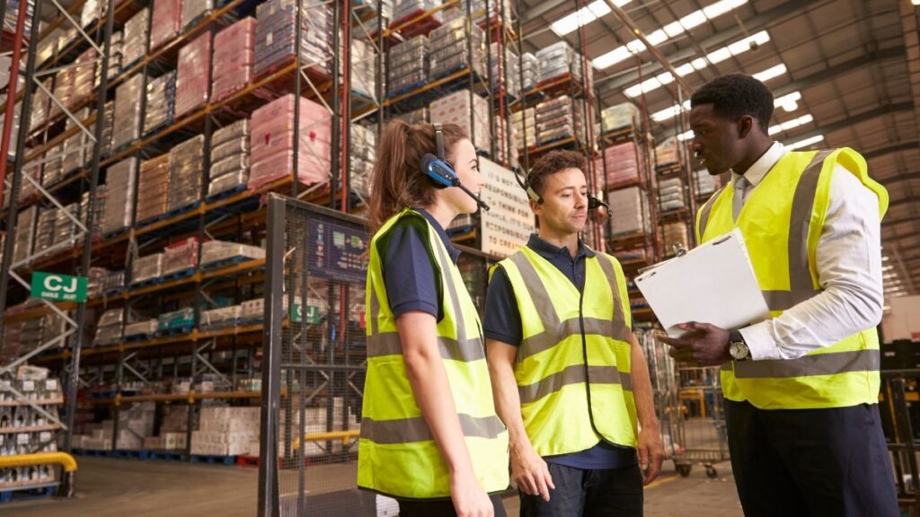 Warehouse team discussing inventory and stock management.